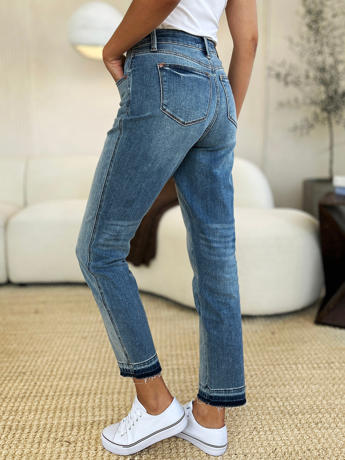 Side view of mid rise rigid magic release hem jeans with moderate stretch, showing full size fit and comfortable wear.