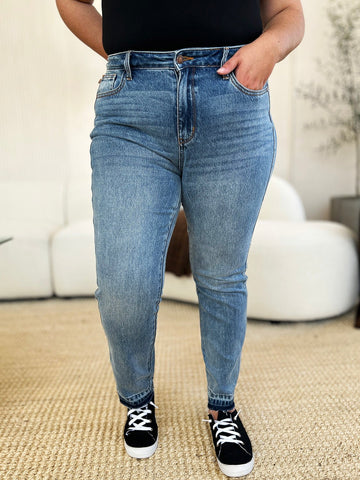 Mid Rise Rigid Magic Release Hem Jeans with moderate stretch, full size, made of cotton blend, worn with black sneakers.