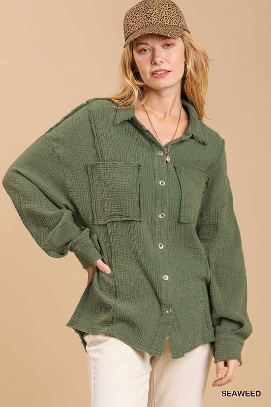 Woman wearing seaweed green mineral wash button down top with high low hem and cap.