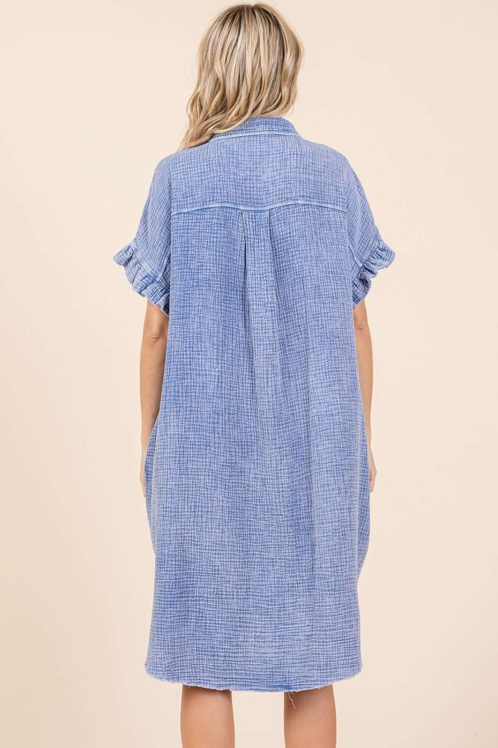 Mineral wash cotton gauze mini shirt dress, buttoned, ruffled, with exposed seam and raw hem, back view of garment