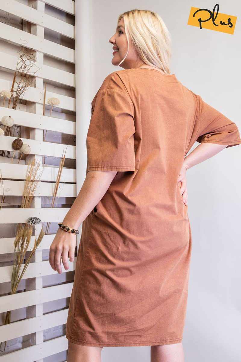 Woman wearing faded rust mineral washed loose fit dress, showing back view with knee-length design and oversized silhouette.