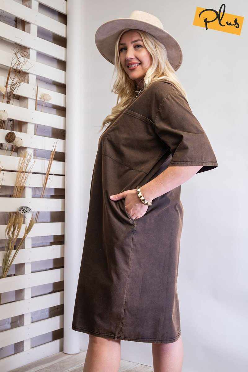 Woman wearing mineral washed loose fit dress with pockets and hat, side view, showcasing slouchy silhouette and oversized design.