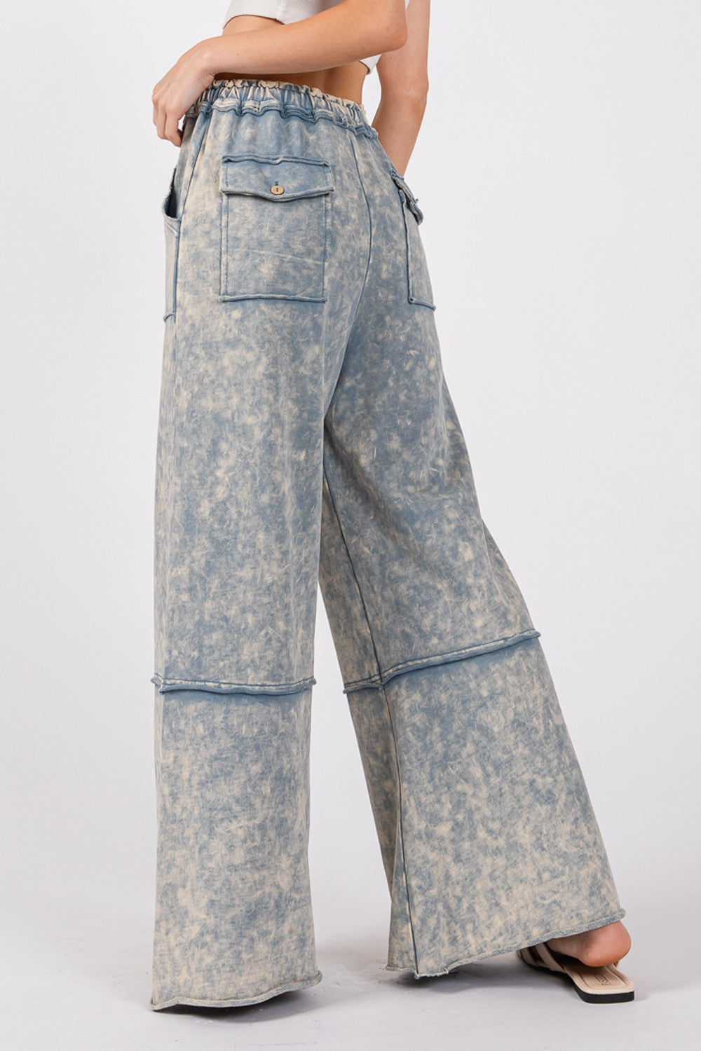 Mineral washed terry wide leg pants in slate blue with elastic waistband and drawstring, showcasing back pocket detail.