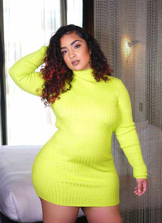Woman wearing Kissed Lime Green Mini Dress in bright room with chain curtain background.