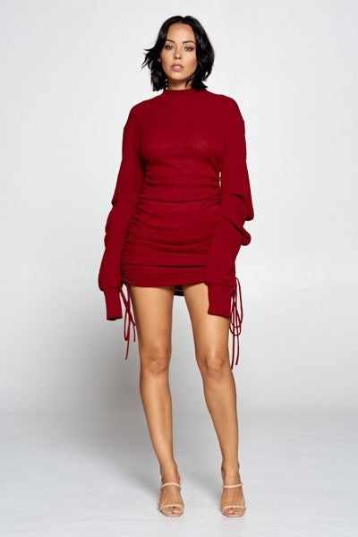 Burgundy mock neck mini bodycon dress with ruched sides and drawstrings, long sleeves, made in USA, polyester-spandex blend.