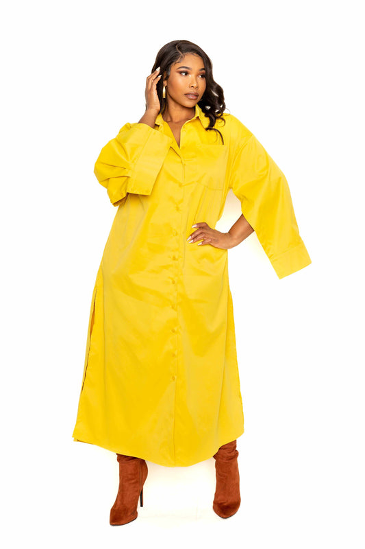 Mustard cape sleeve shirt dress in 100% polyester, available in sizes 1XL, 2XL, 3XL, modeled with brown boots.