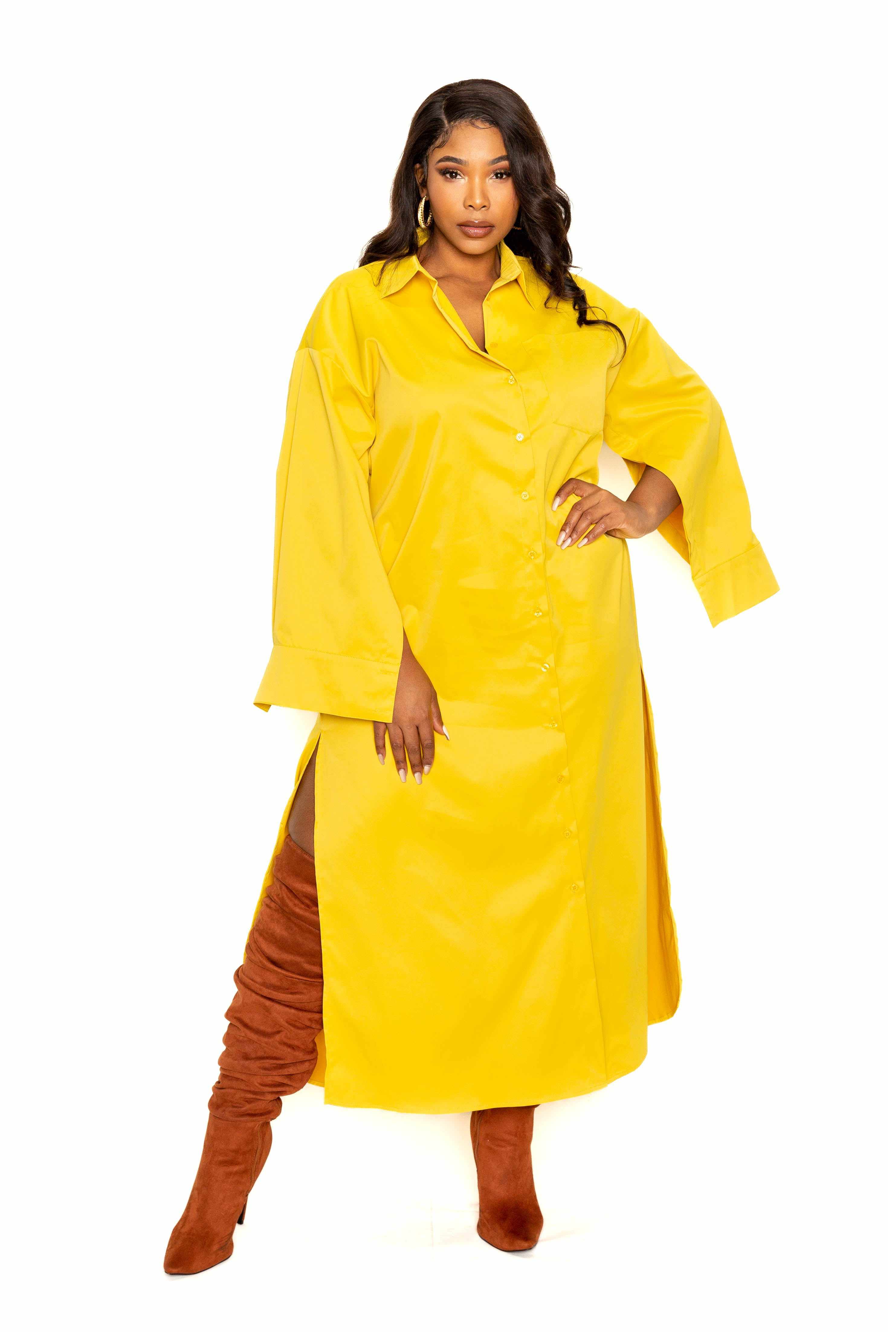 Woman wearing a mustard yellow cape sleeve shirt dress in sizes 1XL to 3XL, showcasing a stylish plus-size fashion look.