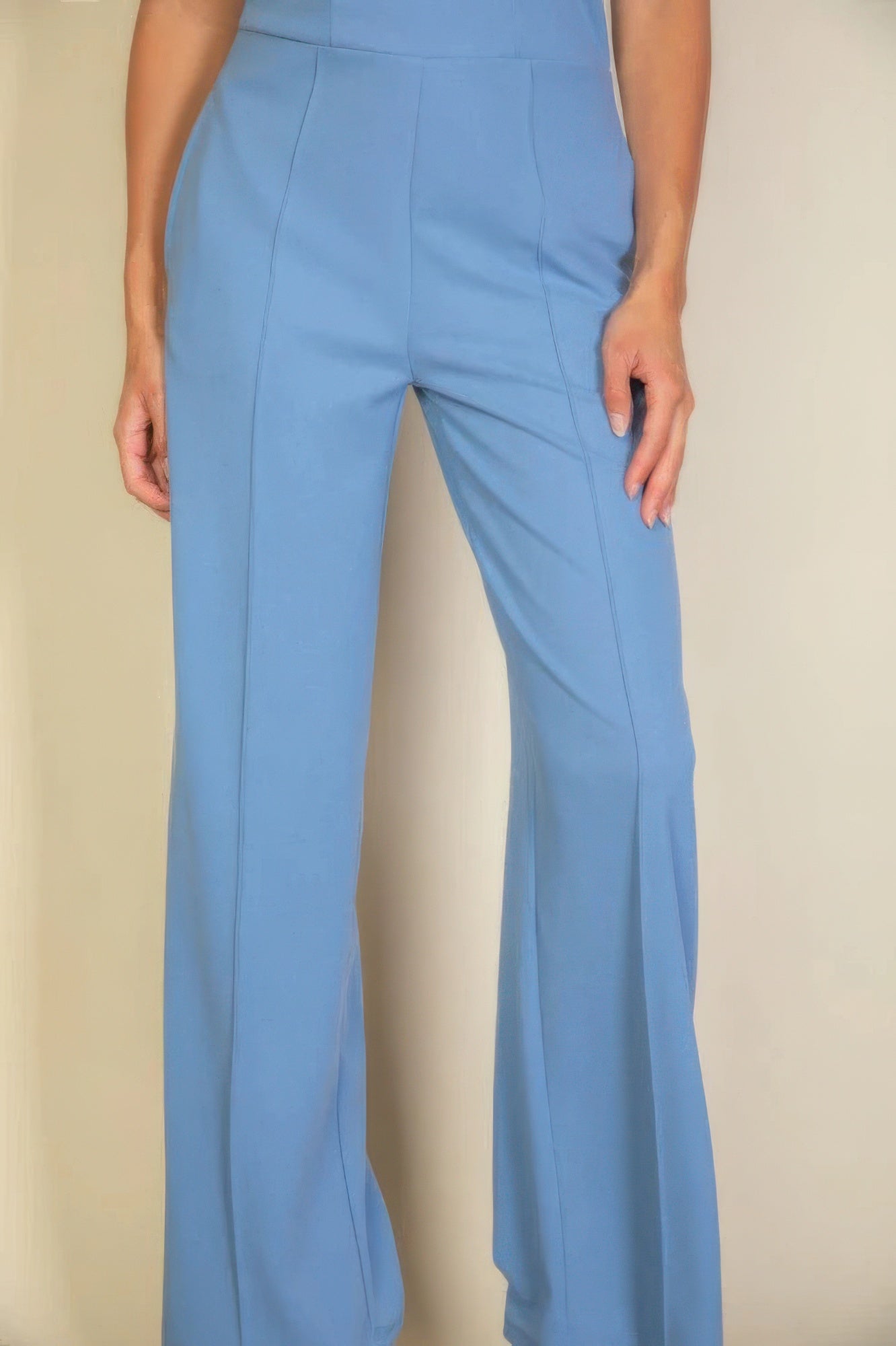 Blue high-waisted pants with tailored fit and sleek design, showcasing modern fashion and elegance suitable for any occasion.