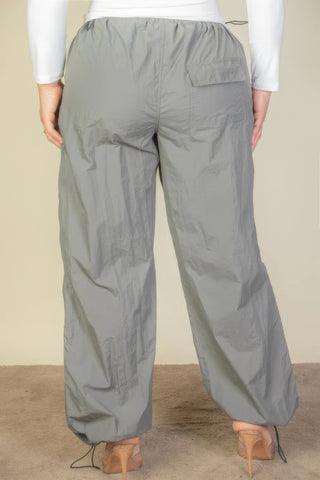 Plus size parachute pants with drawstring waist, back view showing elastic band and pocket detail, gray color.