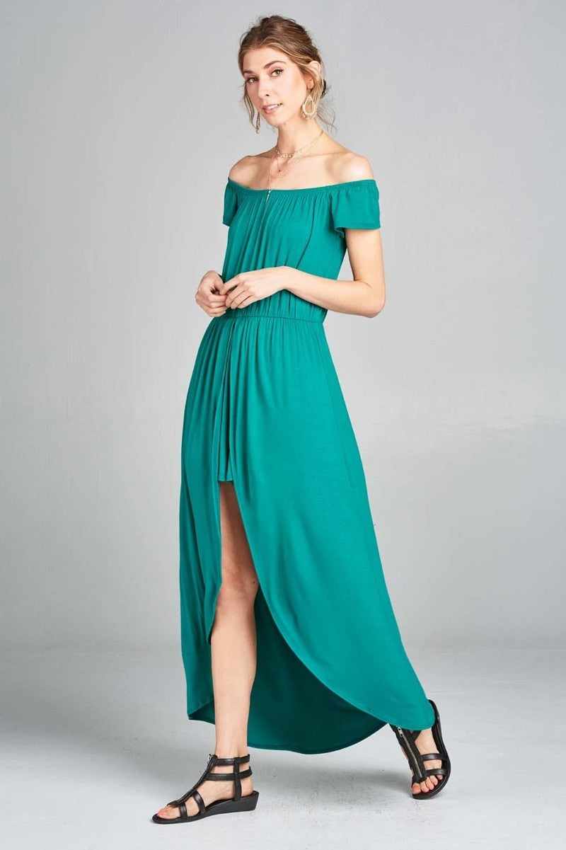 Woman wearing emerald off shoulder solid jersey romper maxi with maxi overlay, comfortable and fashionable statement piece.