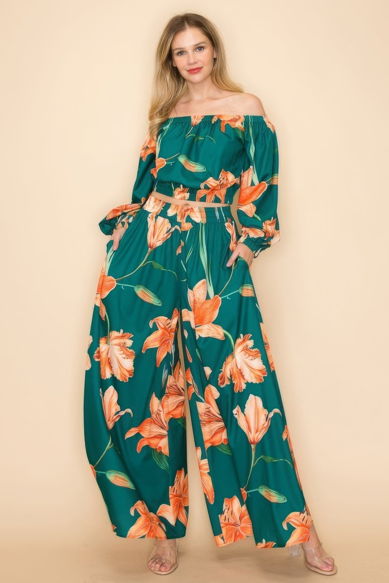 Stylish off-shoulder floral top and wide-legged pants set in green and orange, perfect for versatile fashion statements.