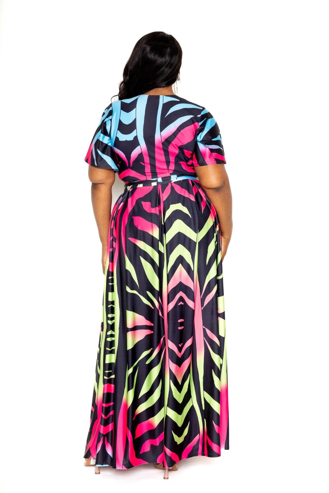 Plus size model wearing ombre animal print maxi skirt and top set in vibrant colors, showcasing back view.