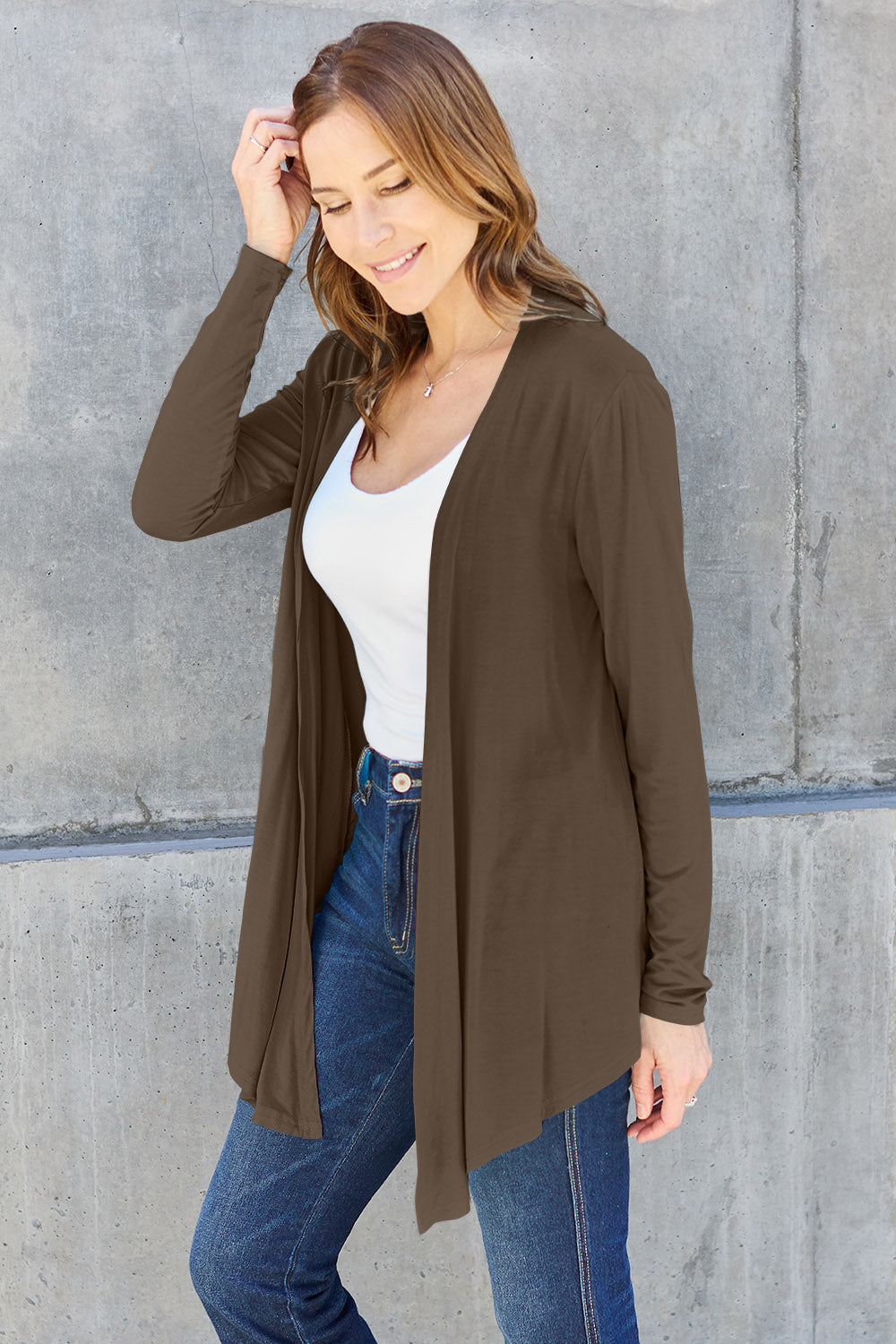 Woman wearing open front long sleeve cardigan, basic style, slightly stretchy, 95% rayon, 5% spandex, casual look.