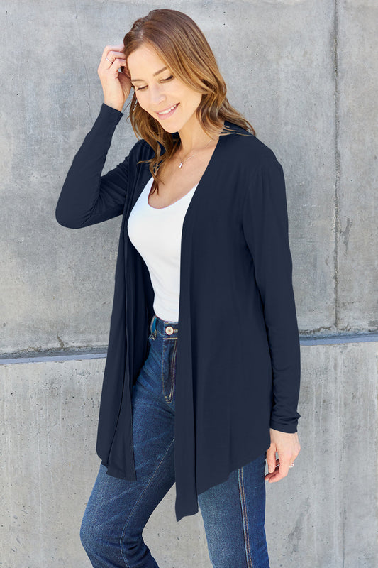 Woman wearing open front long sleeve cardigan with jeans, featuring a basic style and slightly stretchy opaque fabric.