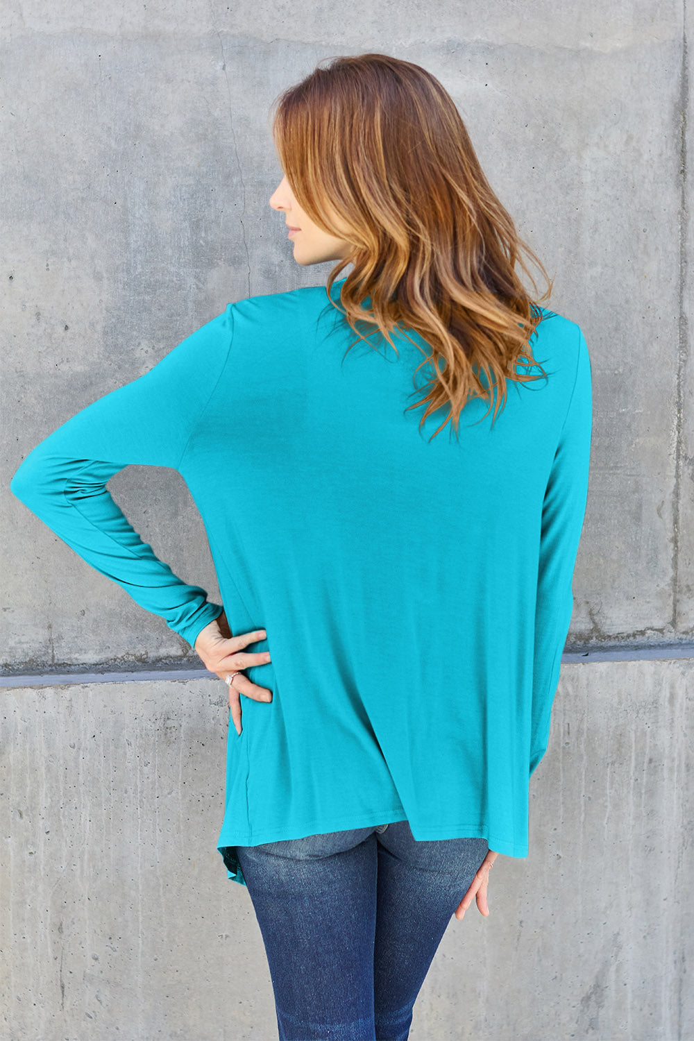 Woman wearing teal open front long sleeve cardigan, showcasing casual back view style in slightly stretchy rayon-spandex material.