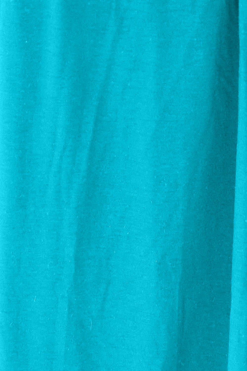 Close-up of turquoise fabric texture with a slightly stretchy and opaque appearance, made of rayon and spandex blend.