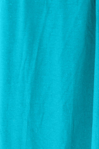 Close-up of turquoise fabric texture with a slightly stretchy and opaque appearance, made of rayon and spandex blend.