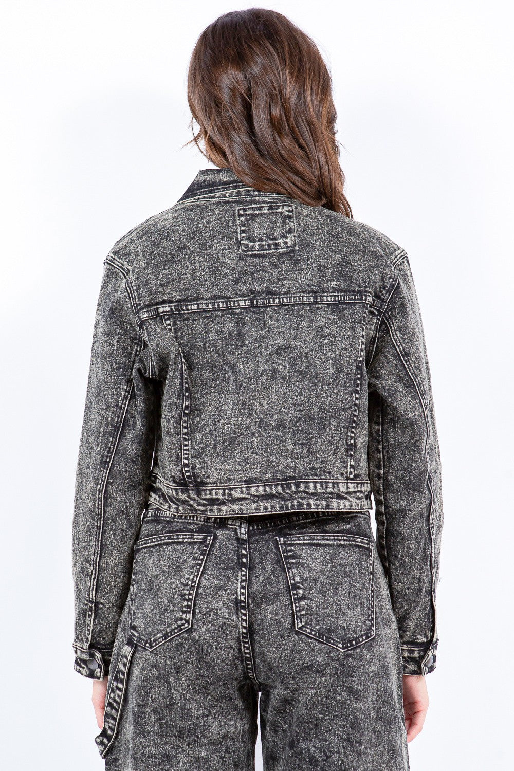 Back view of overdyed bleached zip-up cropped jacket in gray denim, featuring modern silhouette and flexible cotton-spandex blend.