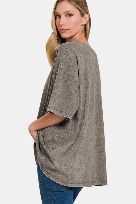 Woman wearing a washed round neck drop shoulder oversized t-shirt in gray with slightly stretchy 100% cotton material.