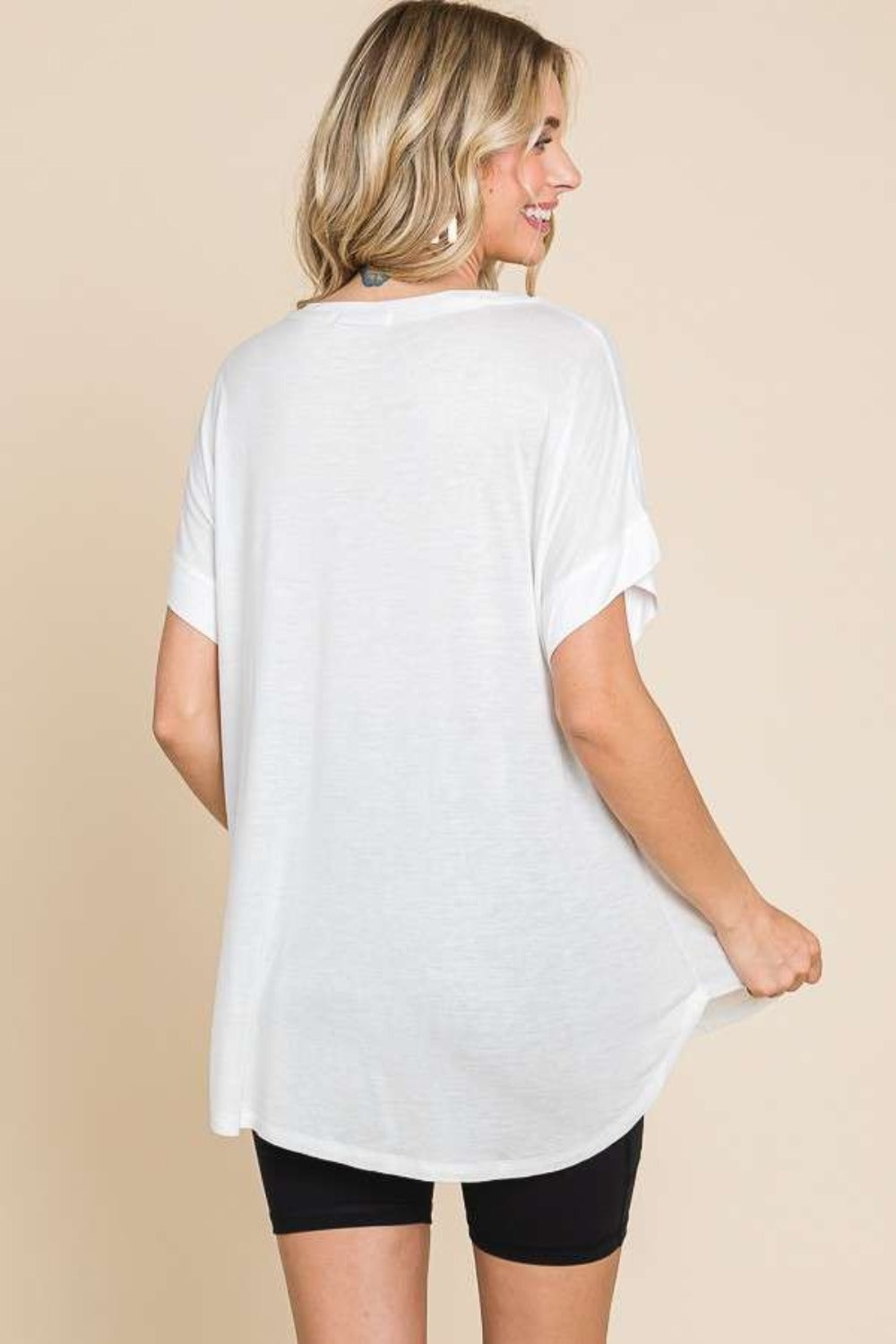 woman wearing white round neck short sleeve t-shirt, showcasing relaxed fit and opaque fabric for versatile casual style