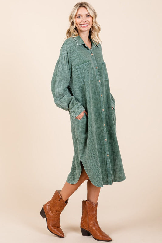 Woman wearing pine mineral wash cotton gauze midi shirt dress with button detail and slit, paired with brown boots.