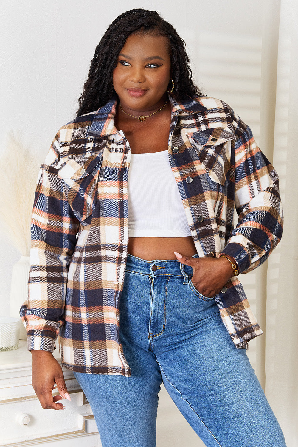 Woman wearing a Double Take Plaid Button Front Shirt Jacket with breast pockets, styled casually with blue jeans.