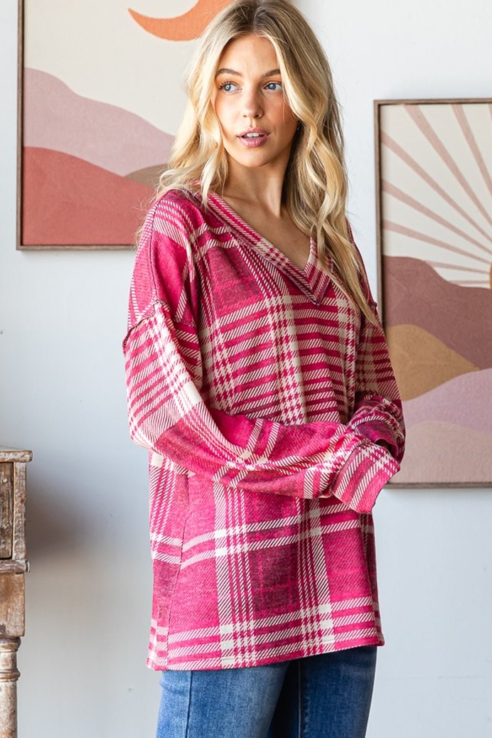 Woman wearing a trendy plaid drop shoulder V-neck T-shirt with an edgy, relaxed look and chic plaid pattern for effortless style.