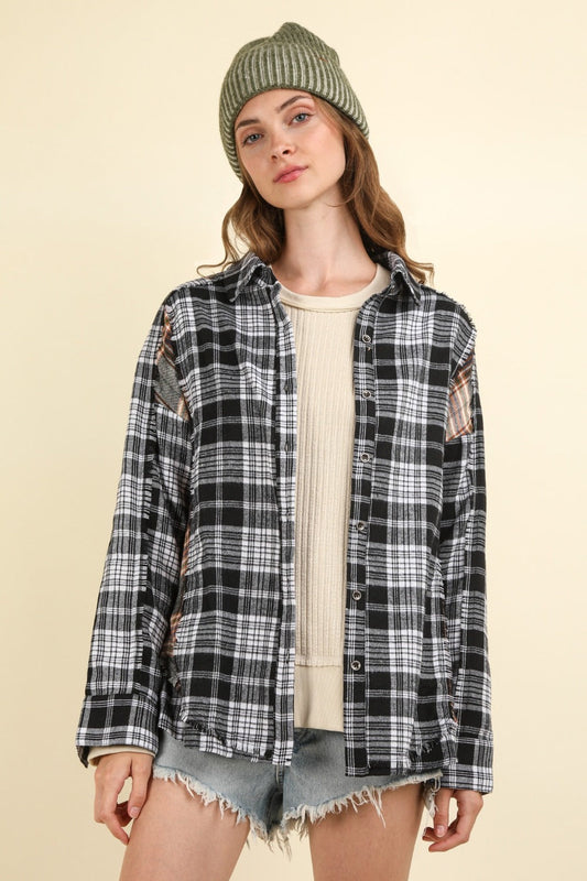 Casual oversized black plaid shirt with raw edge detail, perfect for stylish comfort.