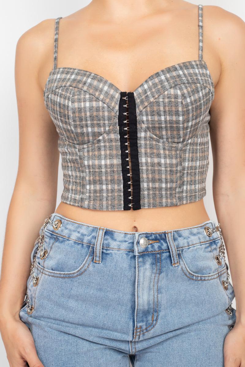 Plaid hook & eye sweetheart crop top with sweetheart neckline, adjustable straps, and front closure, worn with blue jeans.