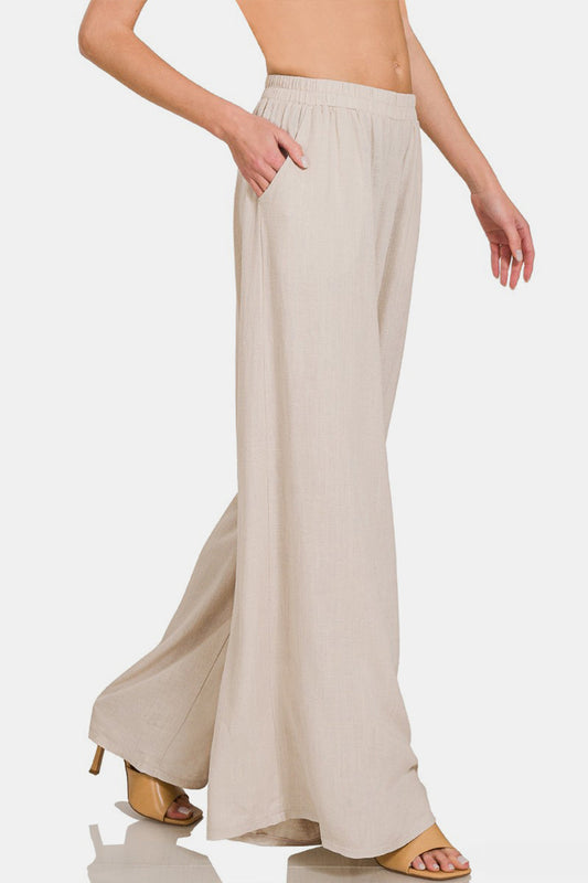 Wide leg pleated linen blend pants with pockets, featuring a comfortable opaque design made of 25% linen and 75% rayon.