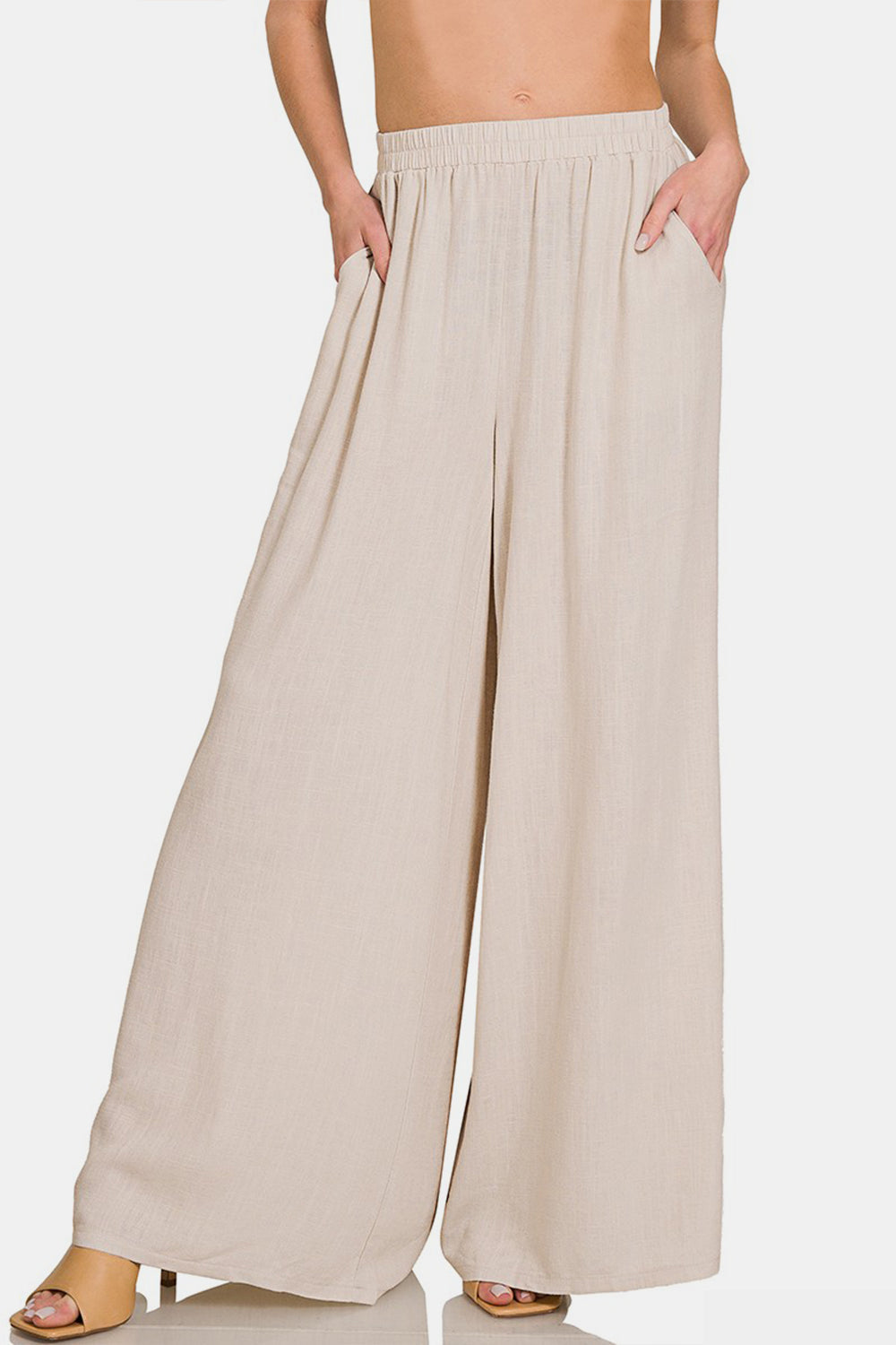 Pleated linen blend wide leg pants with pockets, 25% linen, 75% rayon, opaque material for a relaxed and stylish look.