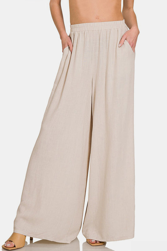 Pleated linen blend wide leg pants with pockets, 25% linen, 75% rayon, opaque material for a relaxed and stylish look.