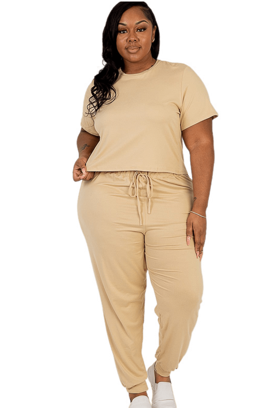 Plus size woman in beige top and pants set showcasing casual wear with soft, stretchy fabric, ideal for daily and workout attire.