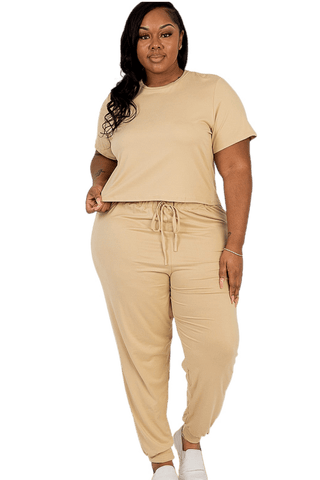 Plus size woman in beige top and pants set showcasing casual wear with soft, stretchy fabric, ideal for daily and workout attire.