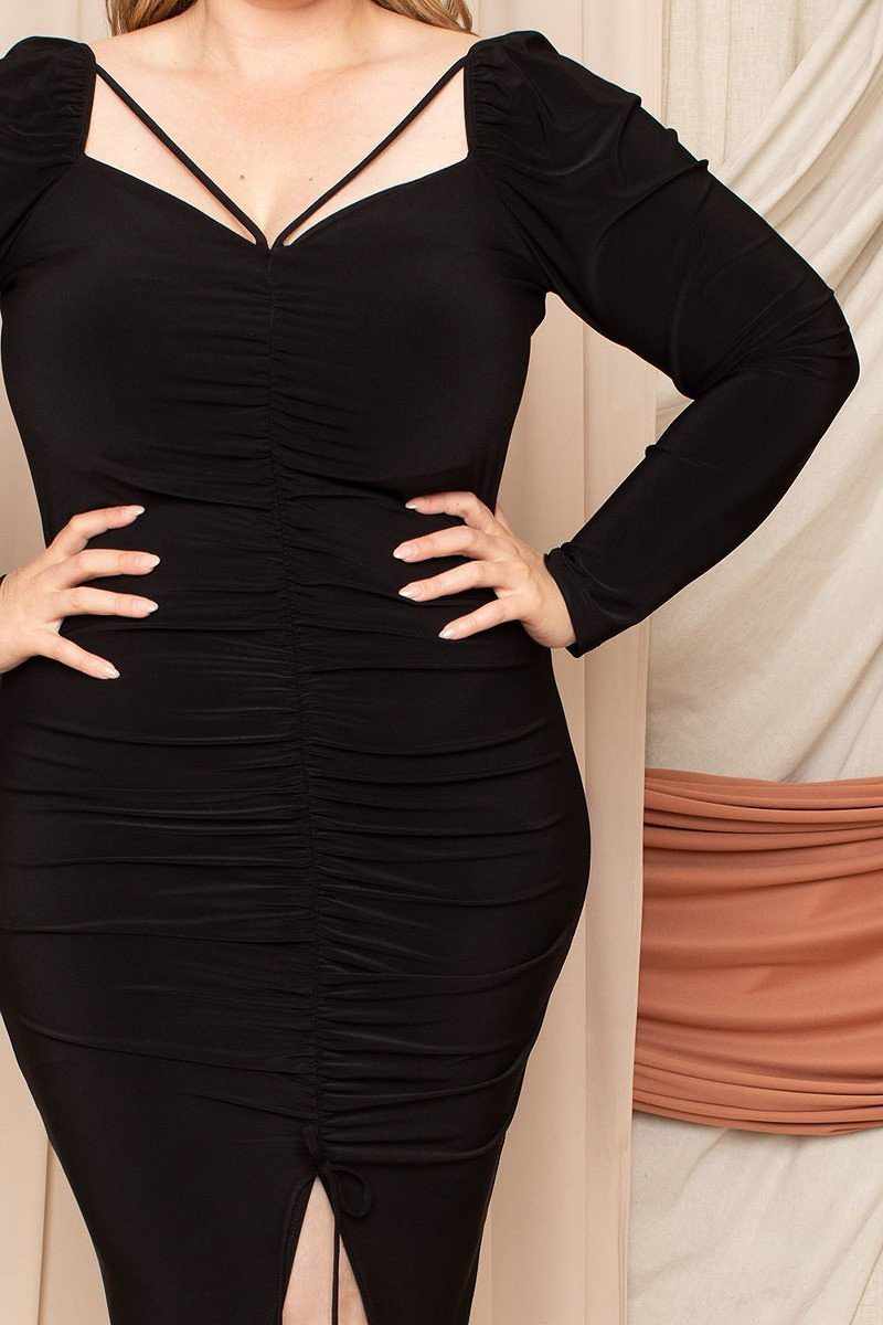 Plus size black dress with deep round neck and shirring detail on the back, made of polyester-spandex blend, USA crafted.