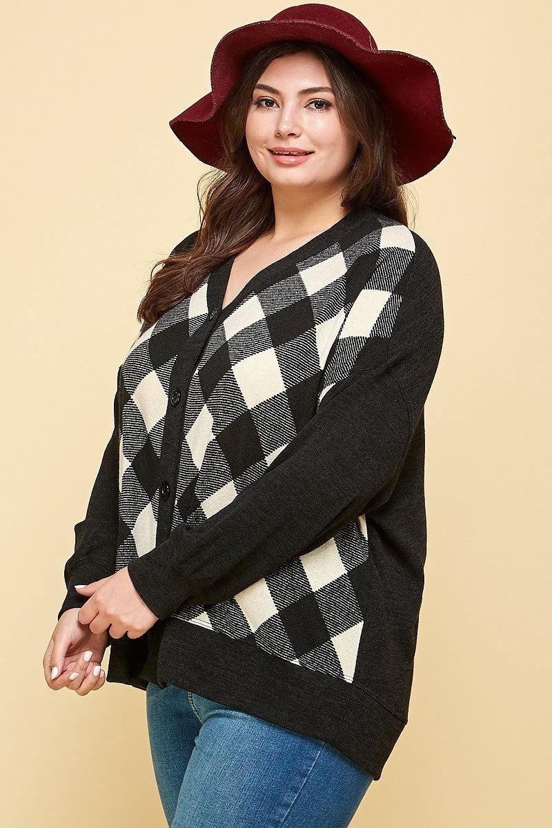 Plus size buffalo plaid oversized cardigan in off-white and black, modeled by a woman wearing a red hat and jeans.