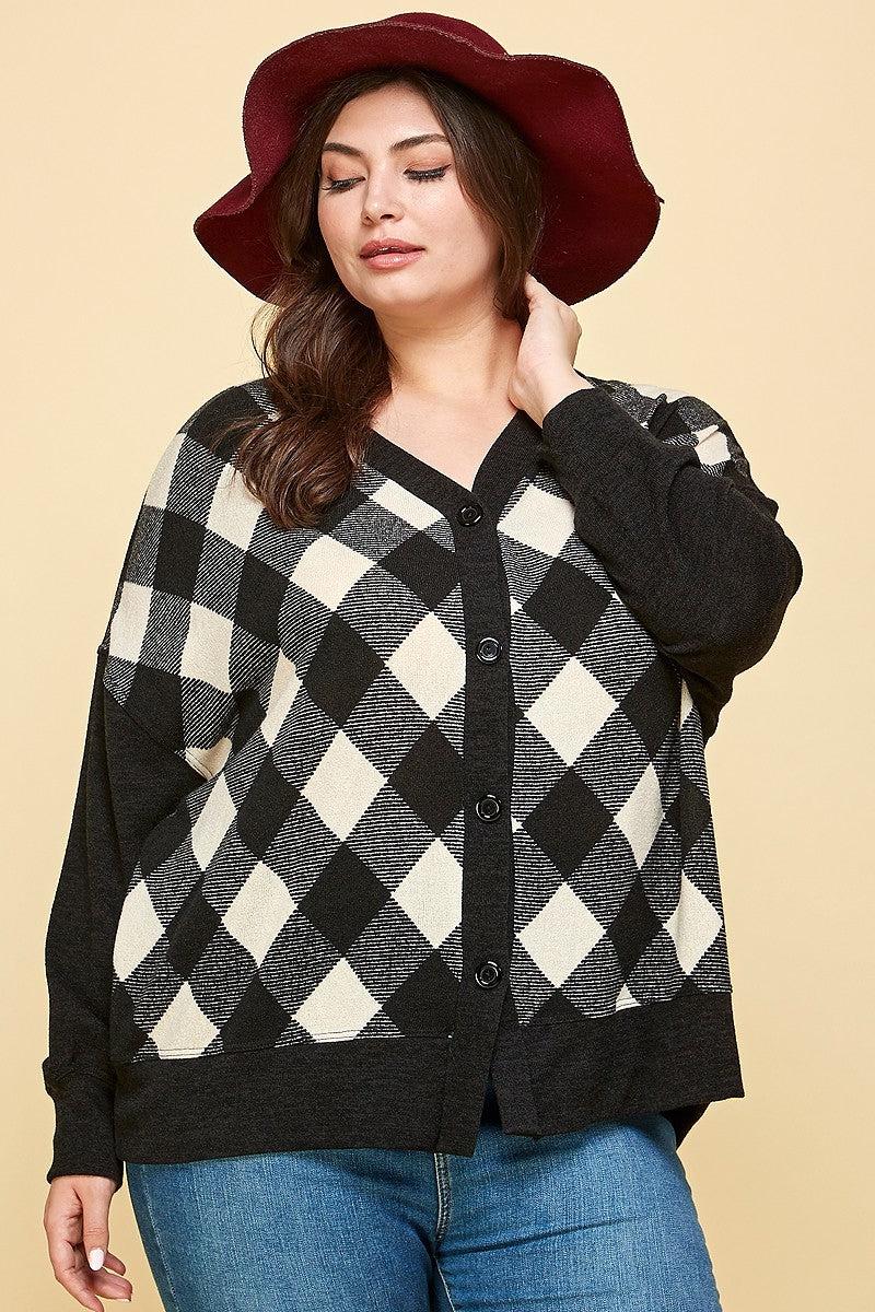 Plus size buffalo plaid oversize cardigan in off white and black, button-up style, modeled with a maroon hat.