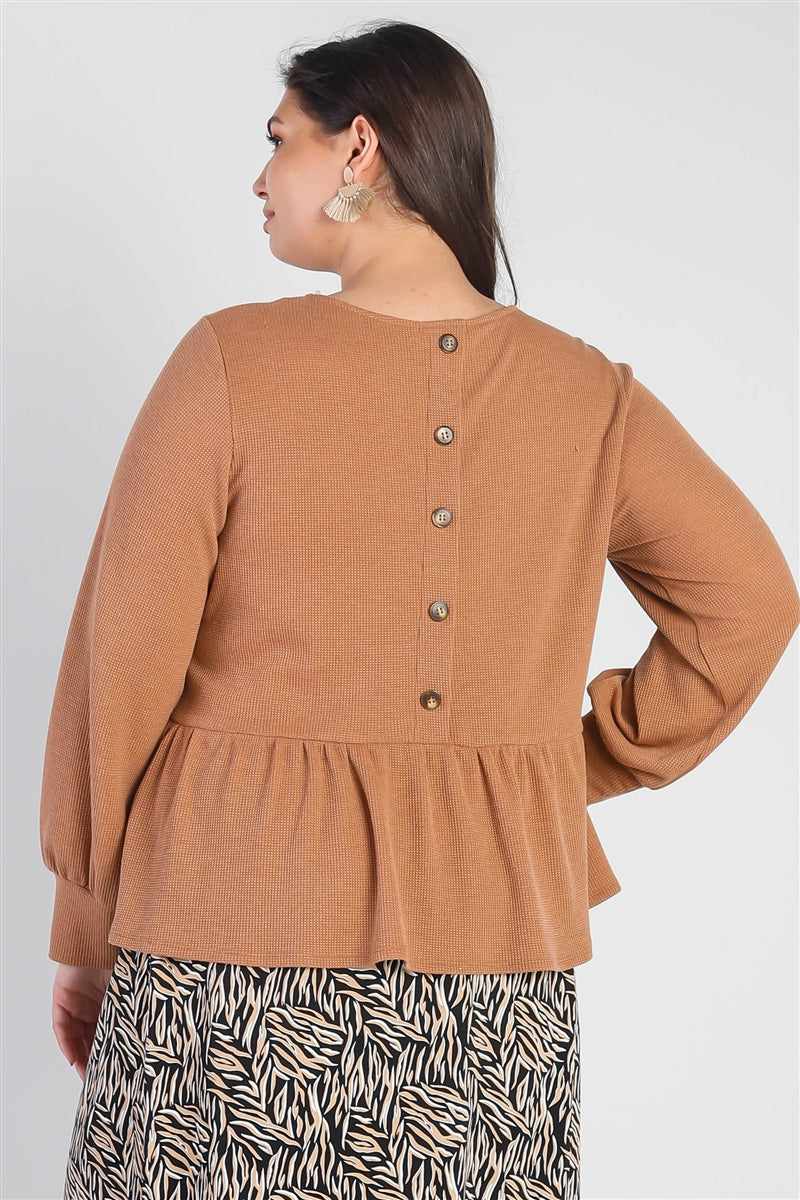 Plus size caramel waffle long sleeve top with back button details, cuffed sleeves, and flare hem, worn for a stylish casual look.