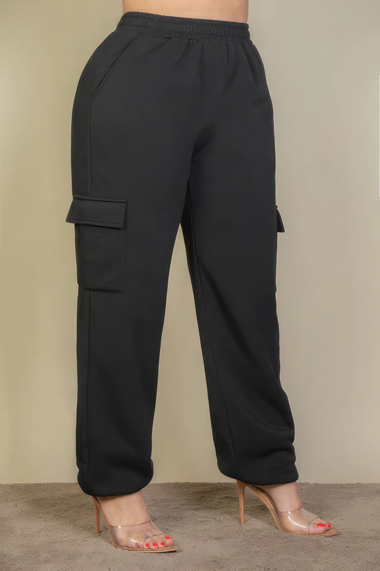 Black plus size drawstring waist sweatpants with side pockets, paired with clear high heels, showcasing a chic and comfortable look.