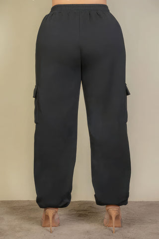 Plus size drawstring waist sweatpants with side pockets, rear view showcasing black soft stretchy fabric.
