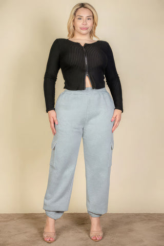 Plus size woman wearing gray side pocket drawstring waist sweatpants and black top, showcasing casual fashion style.