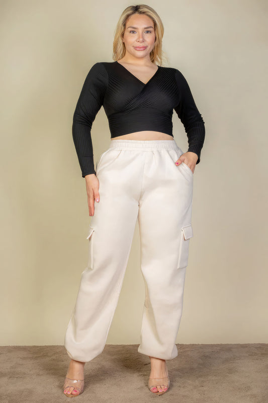 Plus size woman modeling soft drawstring waist sweatpants with side pockets, showcasing comfortable and stylish loungewear.