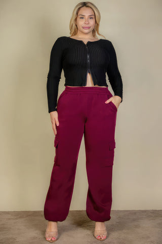 Plus size woman wearing burgundy side pocket drawstring waist sweatpants for comfort and style
