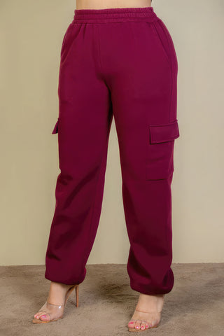Plus size burgundy sweatpants with side pockets and drawstring waist, featuring a relaxed fit and soft fabric.