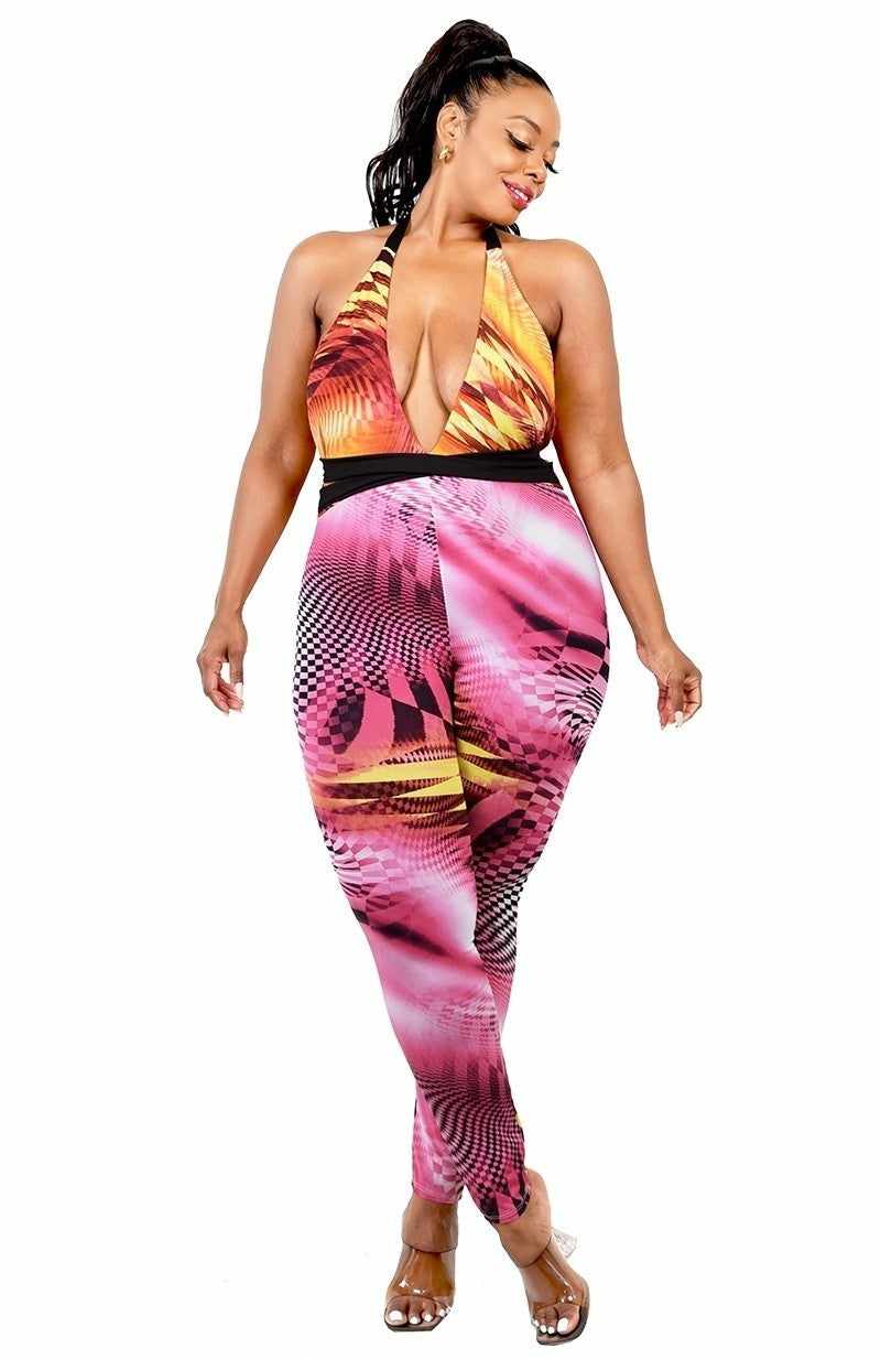 Plus size fuchsia yellow criss cross mock neck jumpsuit with halter neck and cutout design, featuring a vibrant pattern and stretch fabric.