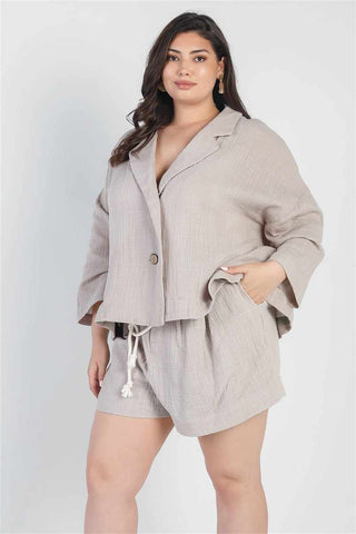 Plus size grey blazer and high waist shorts set with v-neckline and self-tie belt, perfect for a relaxed and stylish look.