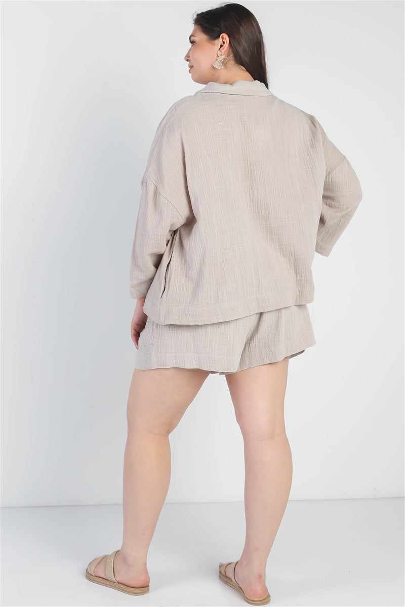 Woman wearing plus size grey blazer and high waist shorts set, featuring cuffed hem and relaxed fit, seen from the back.