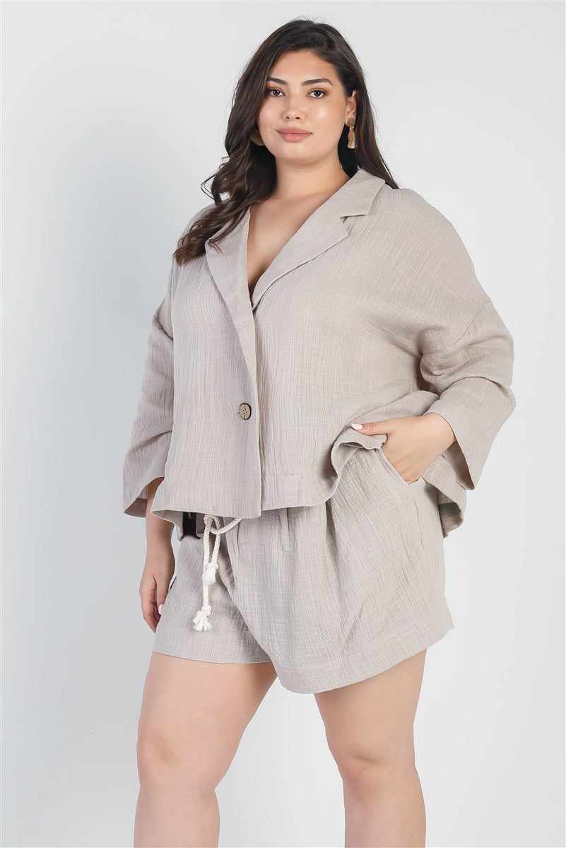 Plus size grey blazer and high waist shorts set with v-neckline and self-tie belt, perfect for a relaxed and stylish look.