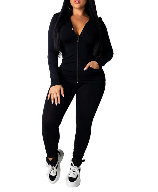 Plus size solid black hoodie and leggings set with zip front, worn with white sneakers, made of polyester and spandex.