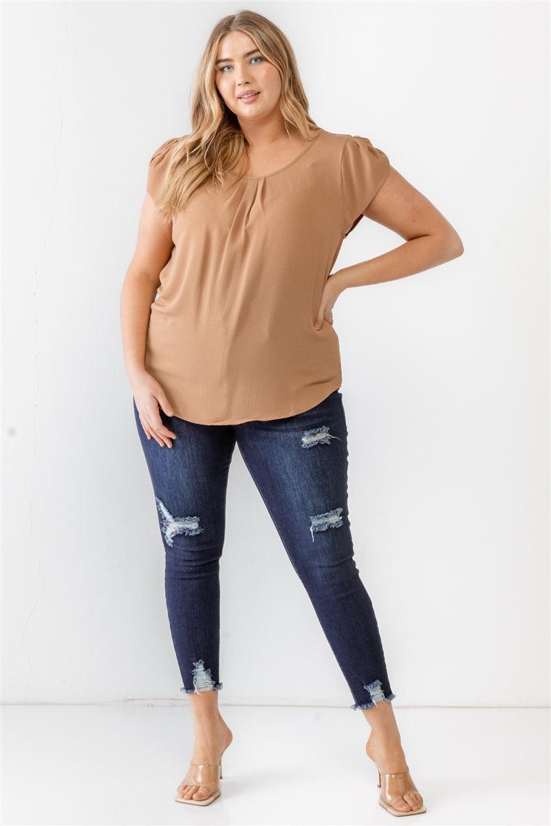 Plus size model wearing khaki textured short sleeve blouse with denim jeans, showcasing casual fashion style.